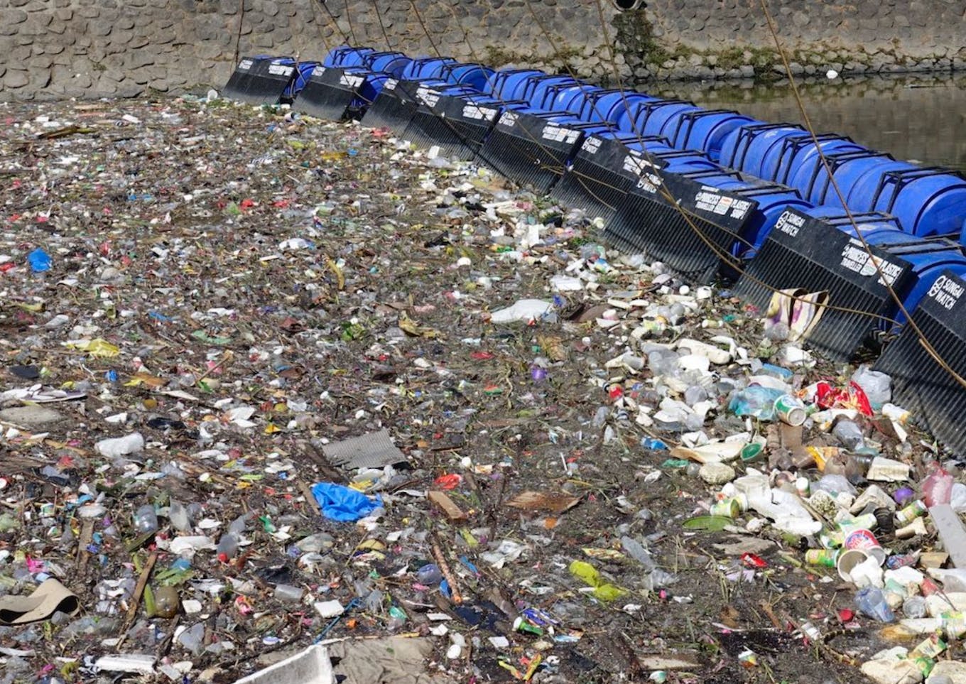 A Sungai Watch river barrier in Indonesia. One quarter of all PET bottles chucked into Indonesian rivers are Aqua branded. Image: Sungai Watch