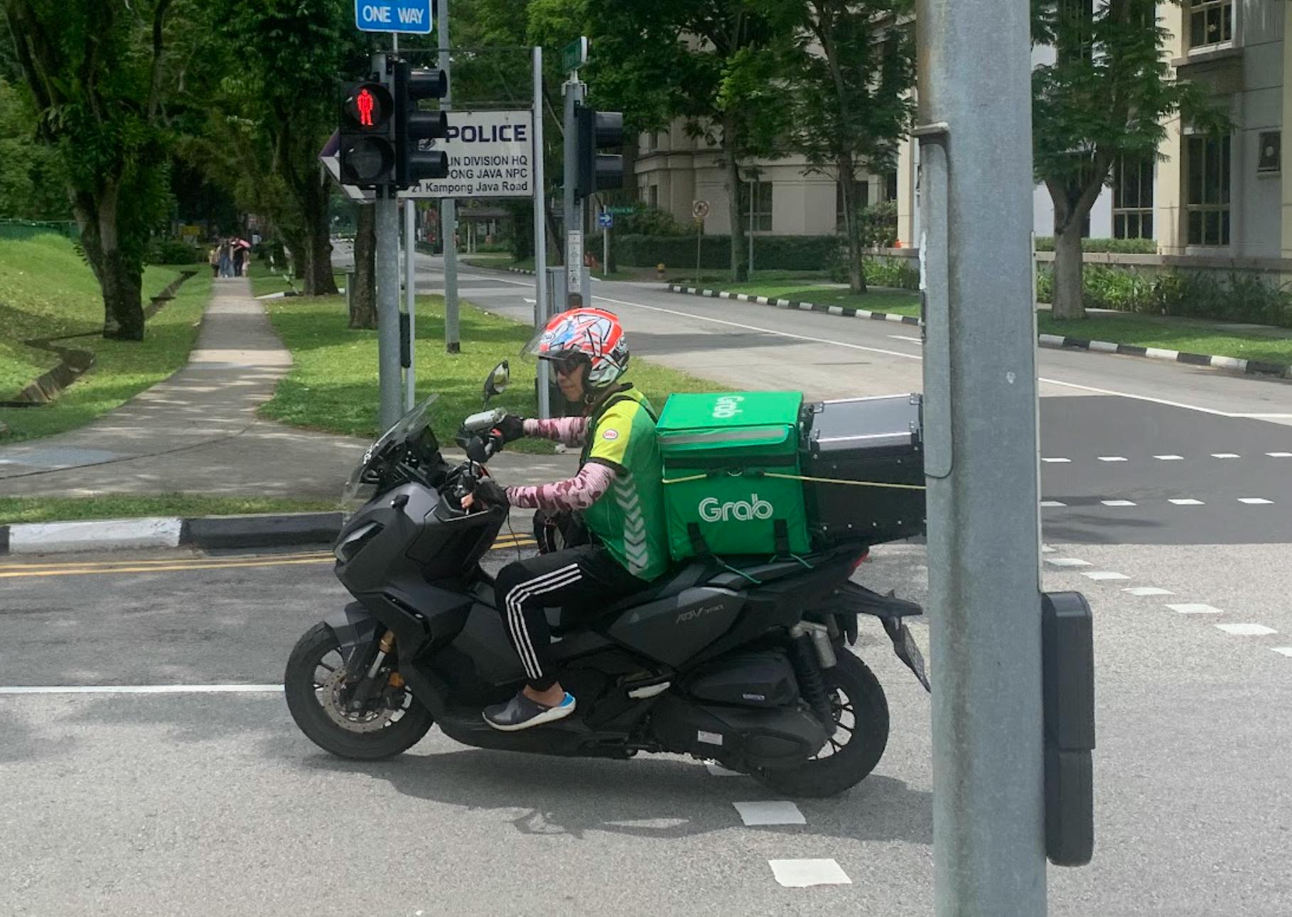 Through the carbon offsetting function on its app, Grab neutralised the emissions of more than 43 million trips and saved about 30,000 tonnes of greenhouse gas emissions in 2022, the company claims. But these claims are based on carbon credits of questionable credibility, according to non-profit RimbaWatch. Image: Robin Hicks / Eco-Business