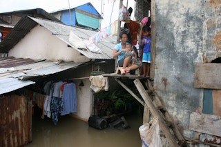 A family living in the northern part of Jakarta, the world’s fastest sinking metropolis, gets on with life as their home is flooded.