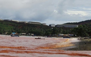 The southern coast of Obi Island, North Maluku, Indonesia. The sea has turned red due to pollution from the nickel mines and smelters.