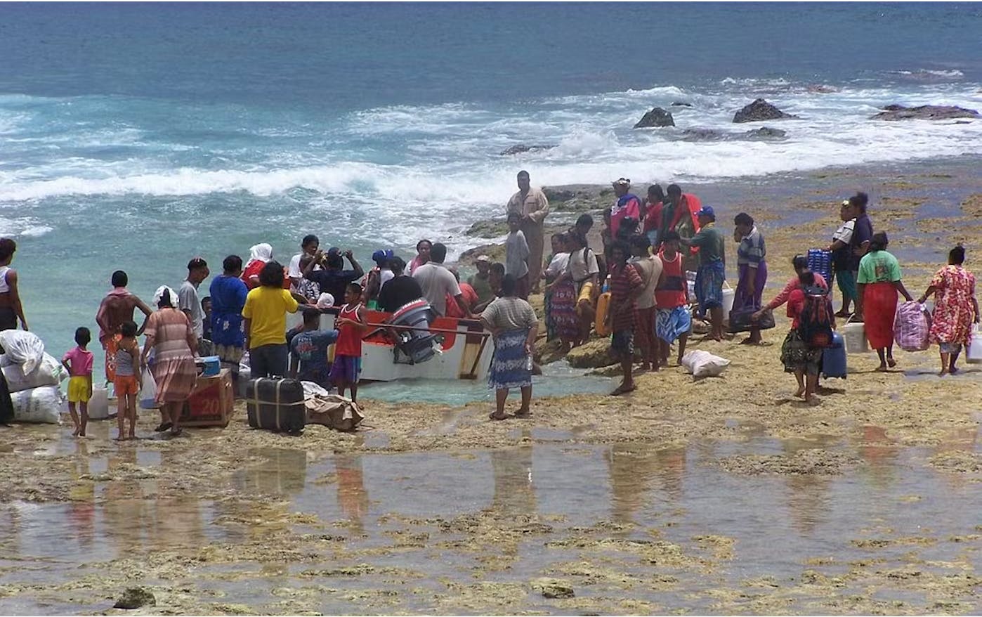 Citizens in Tuvalu wait for cargo to be unloaded