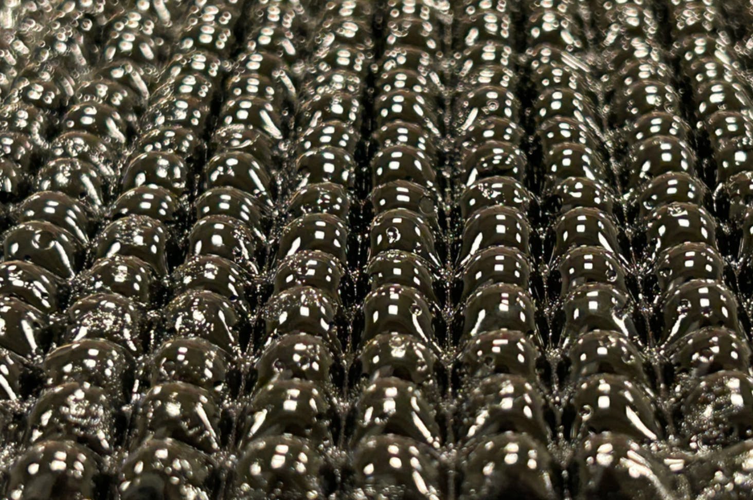 MIT's new device is a black, window-sized vertical panel, made from a water-absorbent hydrogel material, enclosed in a glass chamber coated with a cooling layer.