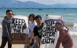 Vietnamese climate campaigners in front of the Vinh Tan coal complex