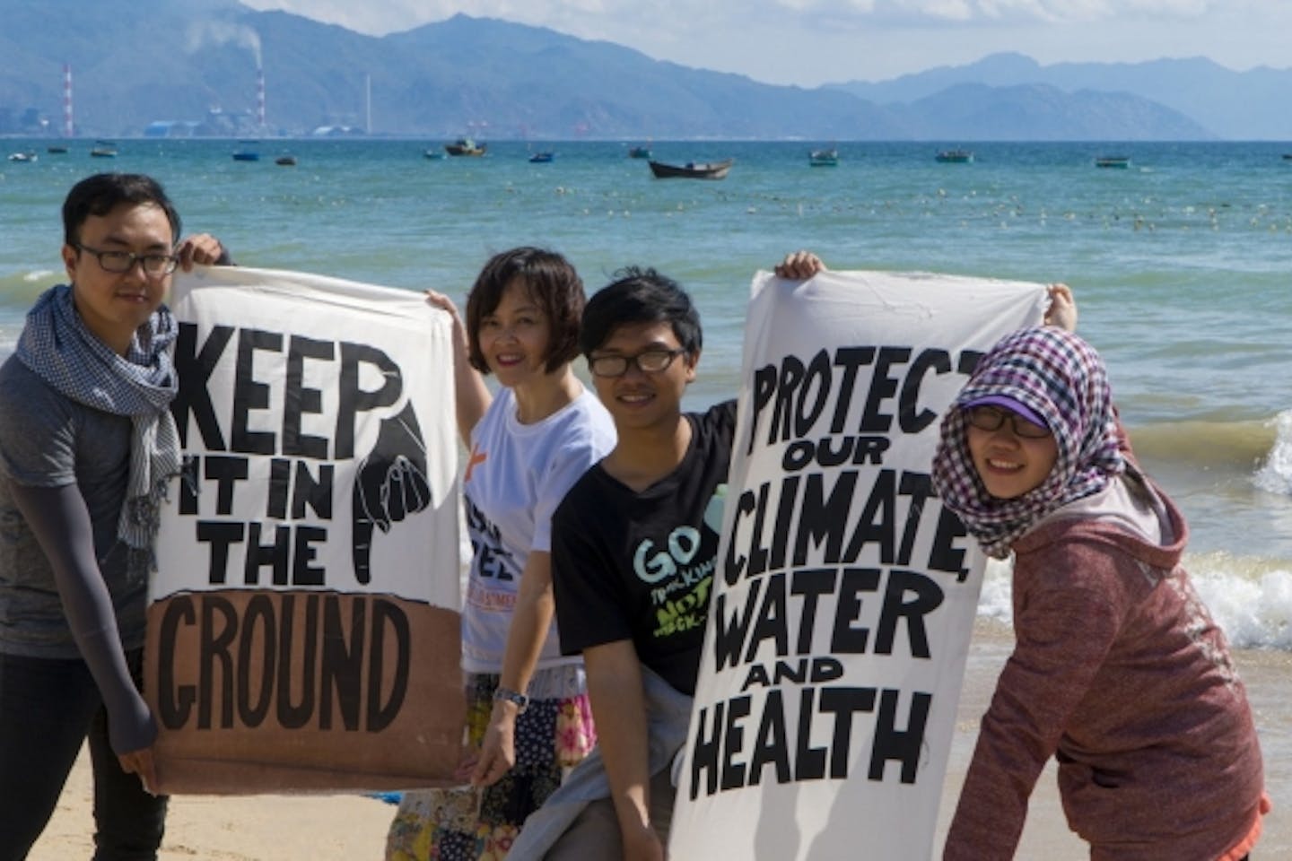 Vietnamese climate campaigners in front of the Vinh Tan coal complex