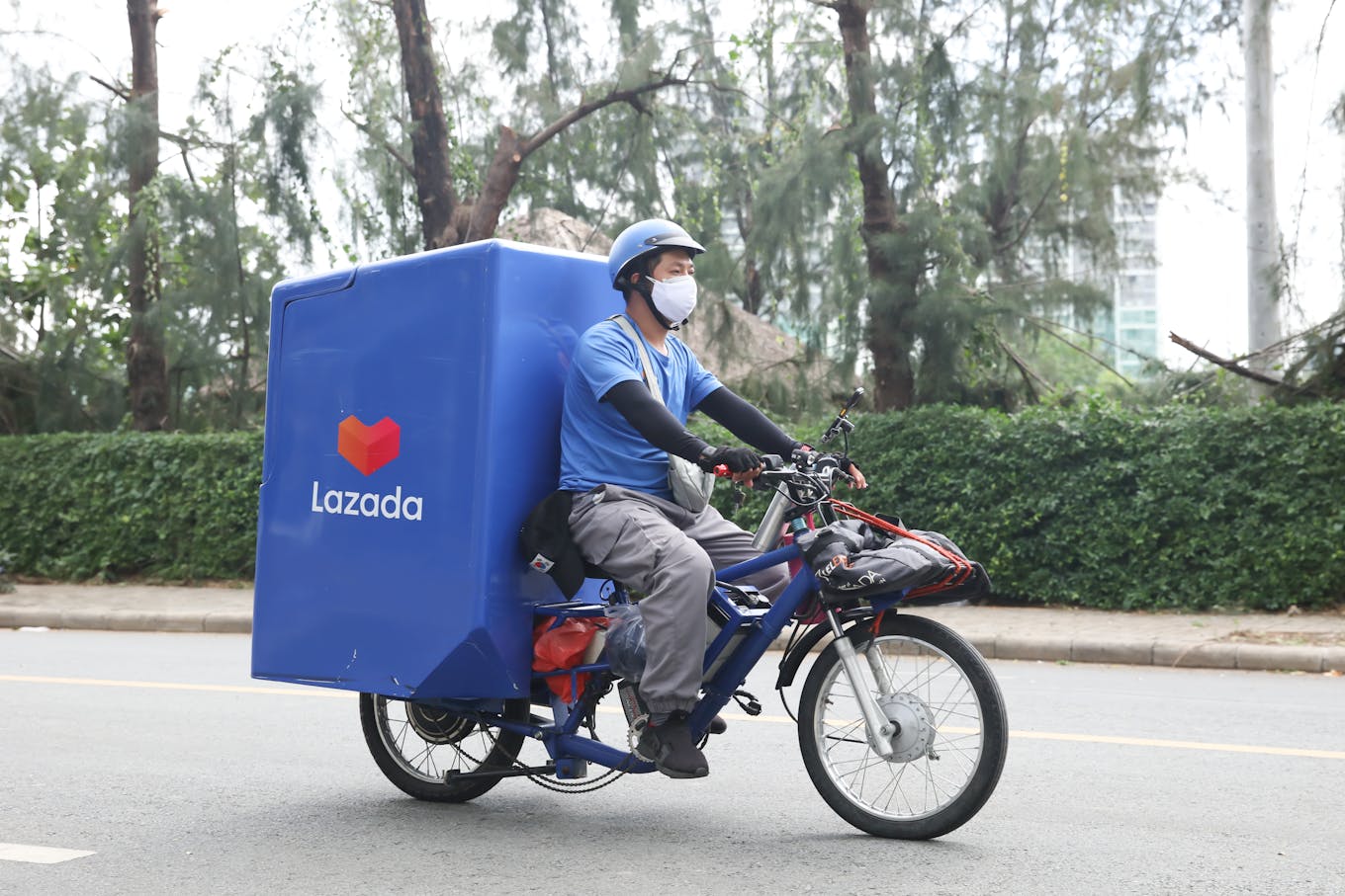 Vietnamese Lazada delivery man in EV