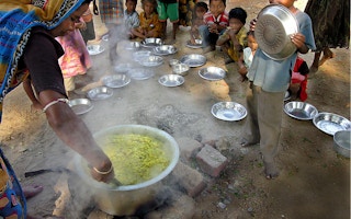 Woman serving the meals at children's school india