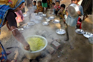 Woman serving the meals at children's school india