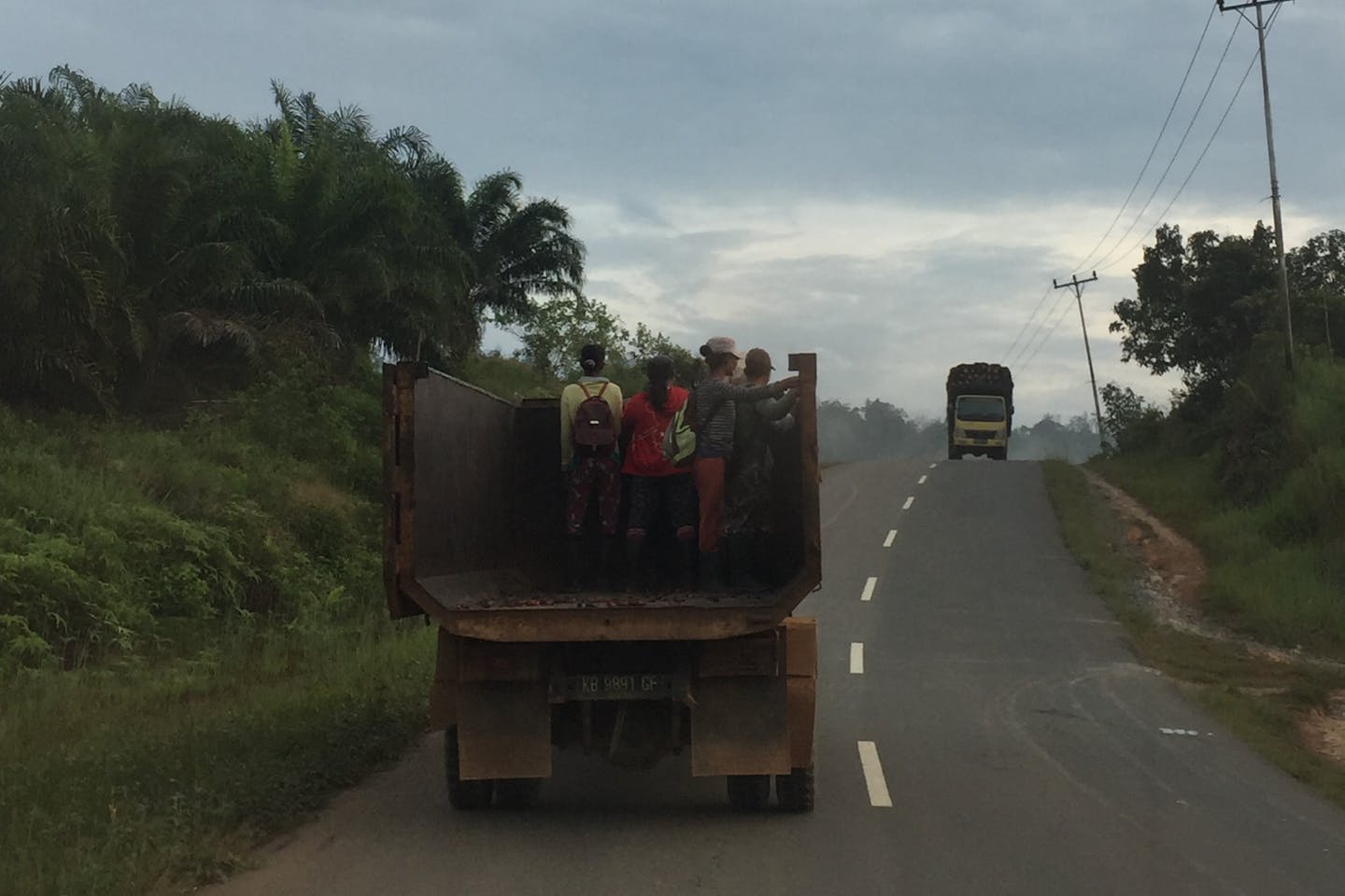 Agricultural workers on their way to a plantation in Western Kalimantan. Image: Robin Hicks/Eco-Business