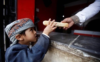 baker gives boy bread in Yemen