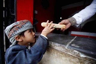 baker gives boy bread in Yemen