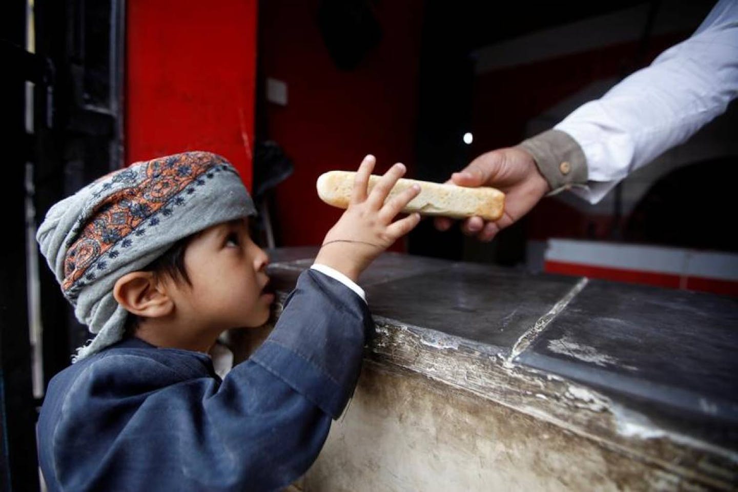 baker gives boy bread in Yemen