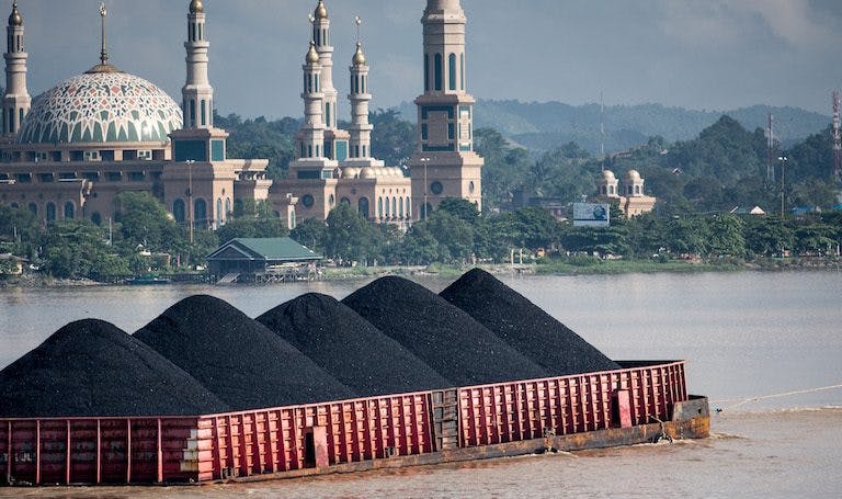 coal barge on the Mahakam River in Samarinda, East Kalimantan, Indonesia