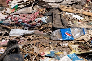A Pepsi model lies amid other debris. Could plastic-using brands save the circular economy? Image: Eco-Business