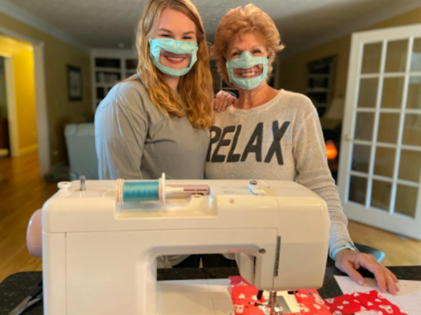 Ashley Lawrence (left) poses with her mother while they both wear a mask made for the deaf and hard of hearing community.