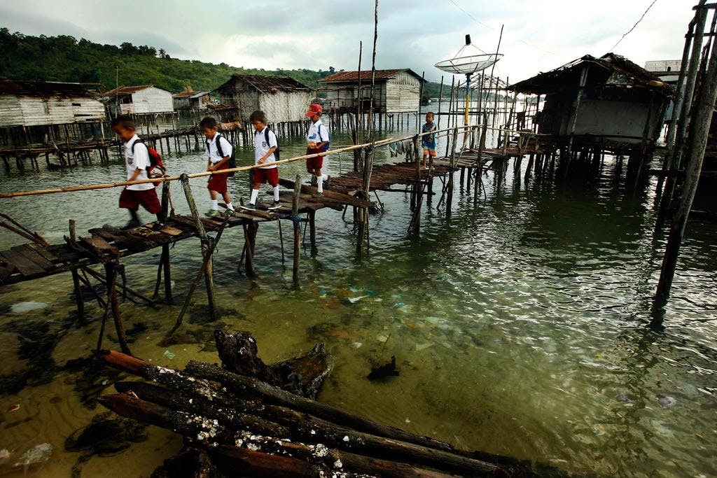 children cross a bridge to school in Sulawesi