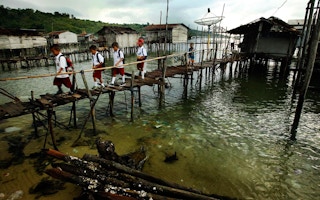 children cross a bridge to school in Sulawesi