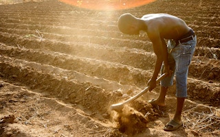 A farmer in Malawi prepares plot for planting