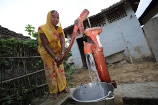 Woman in Nepal drawing water from a tubewell
