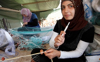 Syrian and Lebanese girls make fishing nets