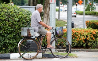 man cycles in Singapore