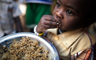 child eats lentils