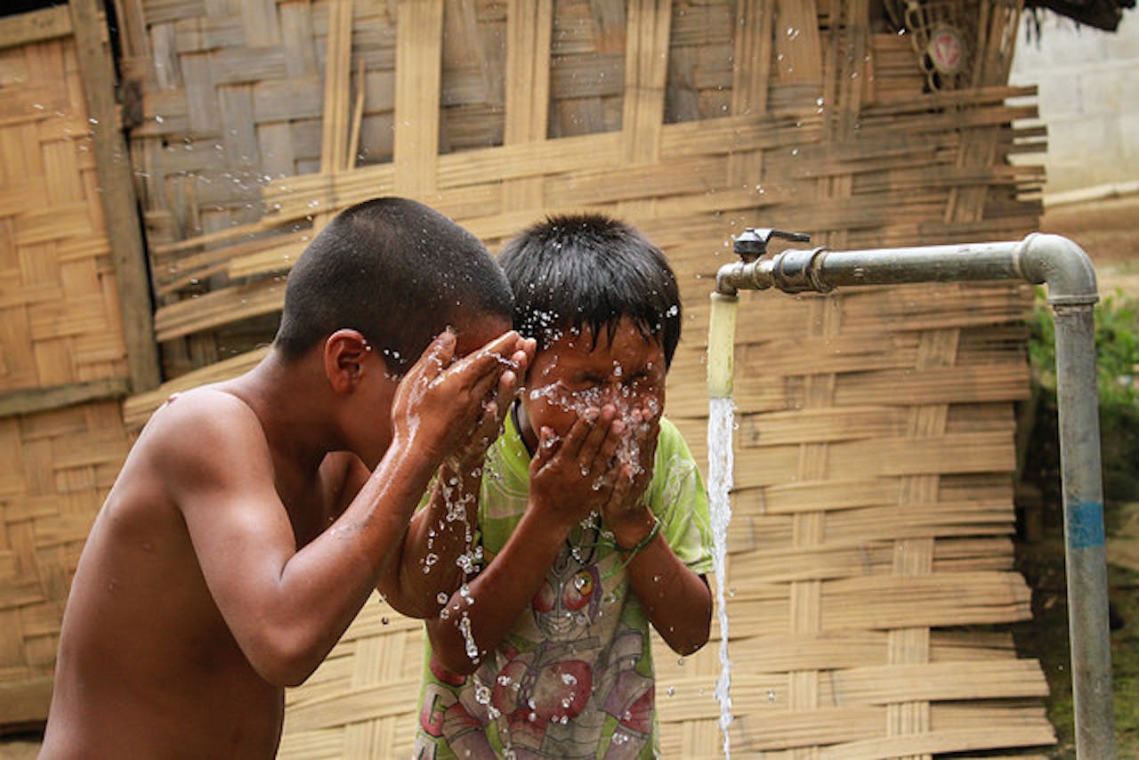 kids cool off with clean water in LAO