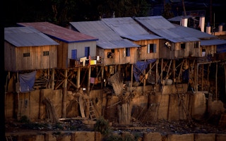 Houses of urban poor built along Basac river bank in Phnom Penh.