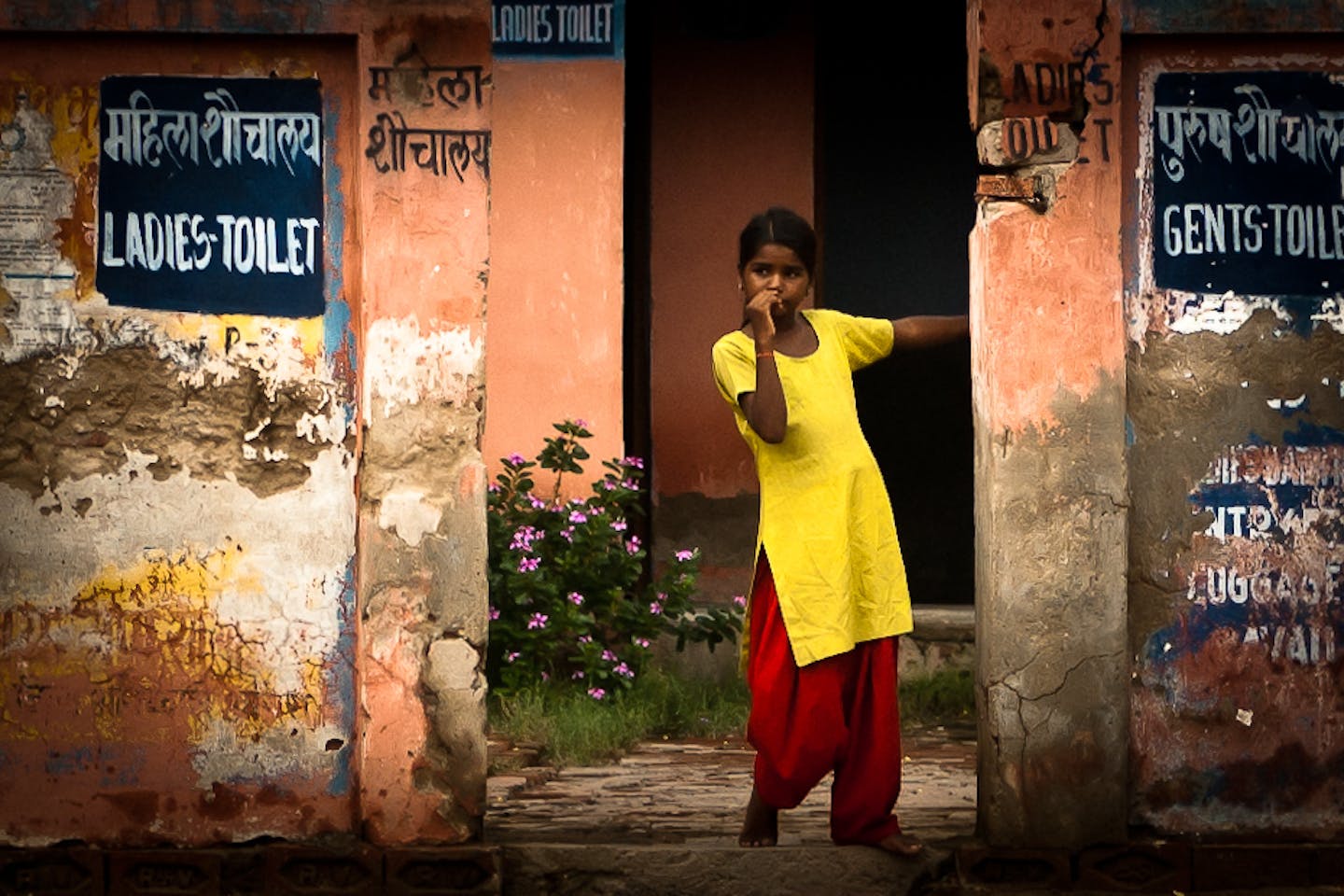little girl stands at toilet in Fatehpur Sikri, India