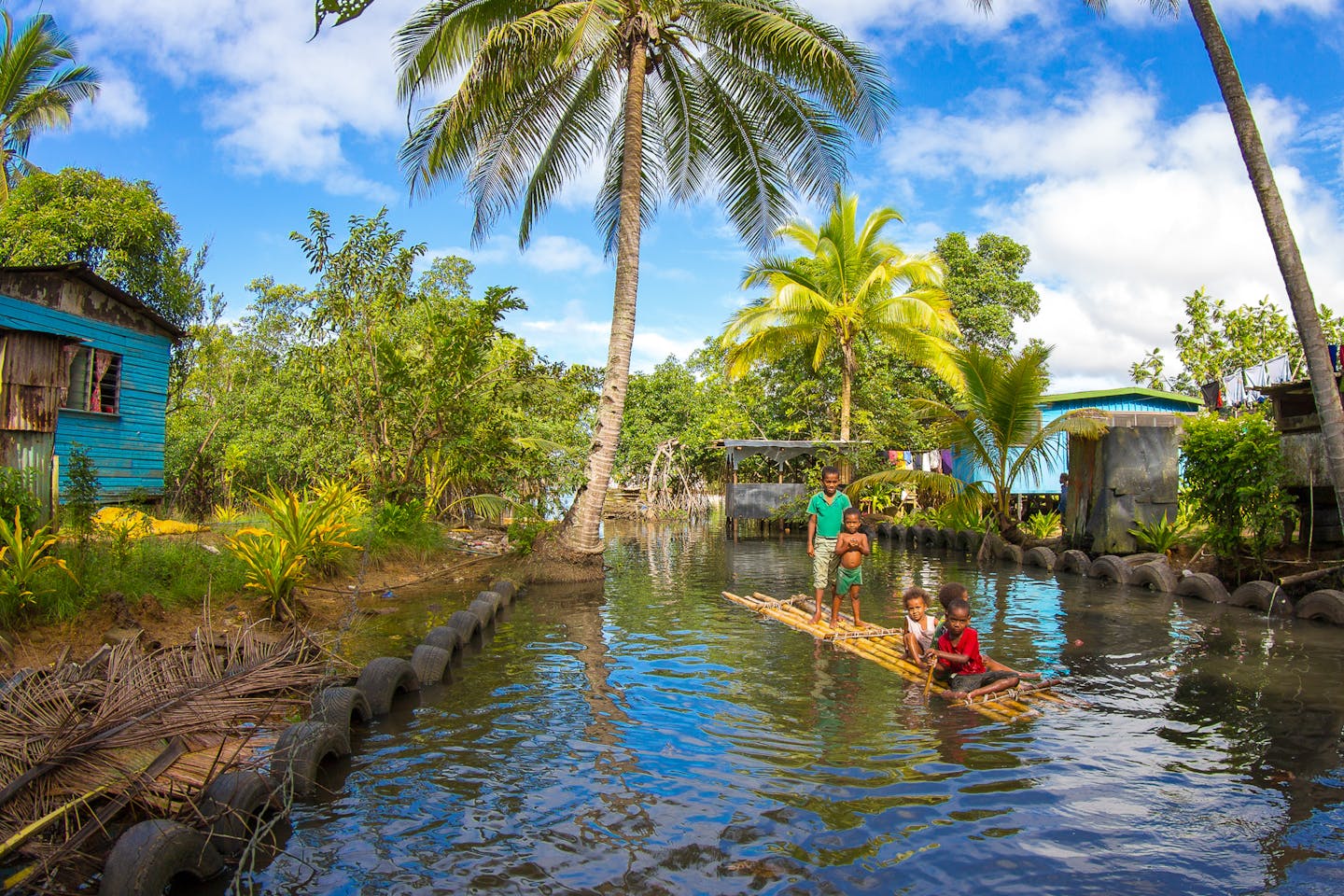 Kids play on their bilibili or traditional raft made from lashed together bamboo, just outside of Lami, west of Suva in Fiji