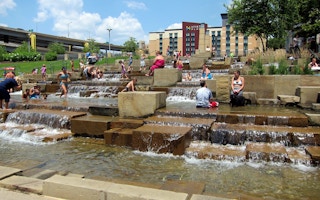 People of Pittsburgh cooling off in a public water fountain