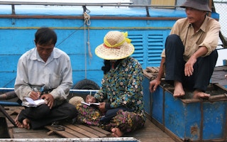 Fishermen in Cambodia balancing their accounts. 