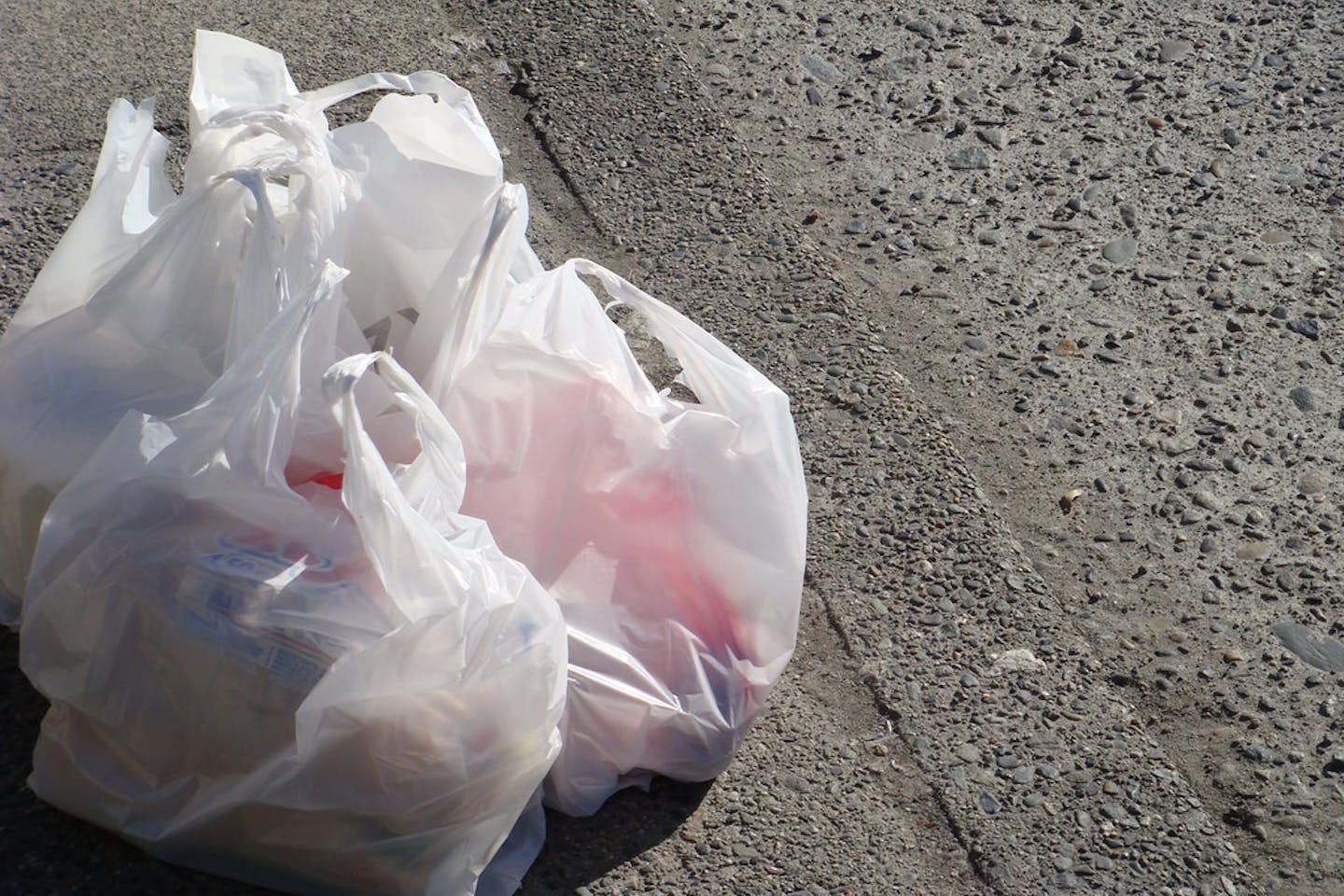 plastic grocery bags on the sidewalk