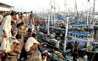 Fishing boats throng Mumbai's Ferry Wharf to unload their cargo and sell some fish