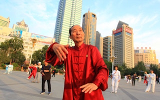 People do taichi in the People's Square of Urumqi, China