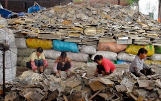 Women in China sort through waste plastics to be sent for recycling.