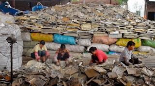 Women in China sort through waste plastics to be sent for recycling.