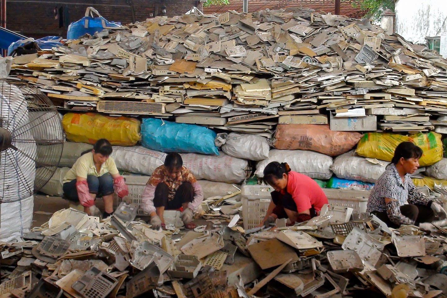 Women in China sort through waste plastics to be sent for recycling.