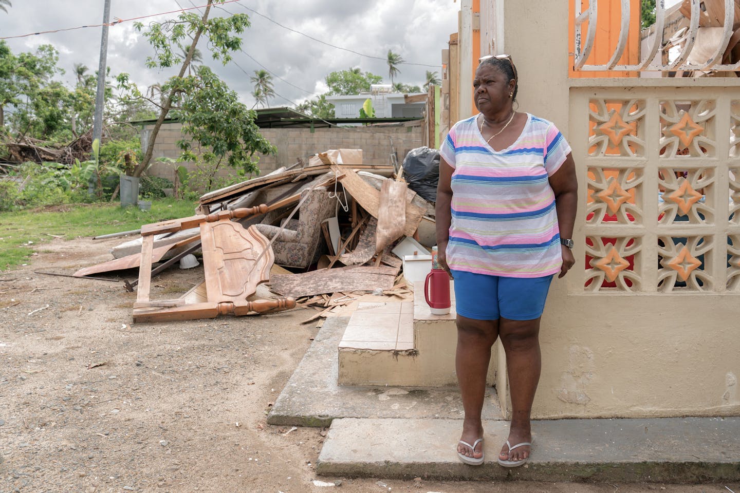 A woman in Loiza at her damaged home in Loíza, Puerto Rico