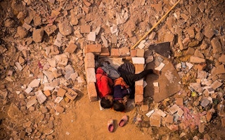 children play in dirt and bricks