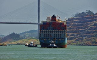 A cargo ship under The Bridge of the Americas