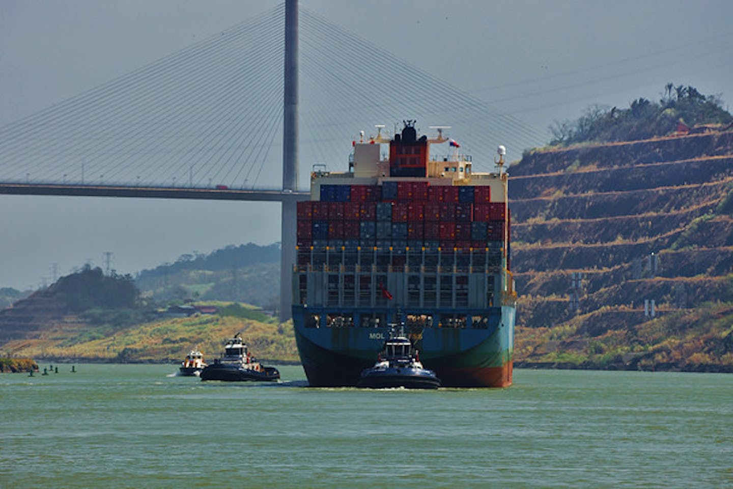 A cargo ship under The Bridge of the Americas
