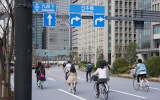 Cyclists on the road in Tokyo, Japan