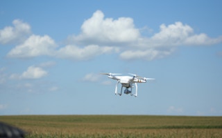 A drone hovers over a farm