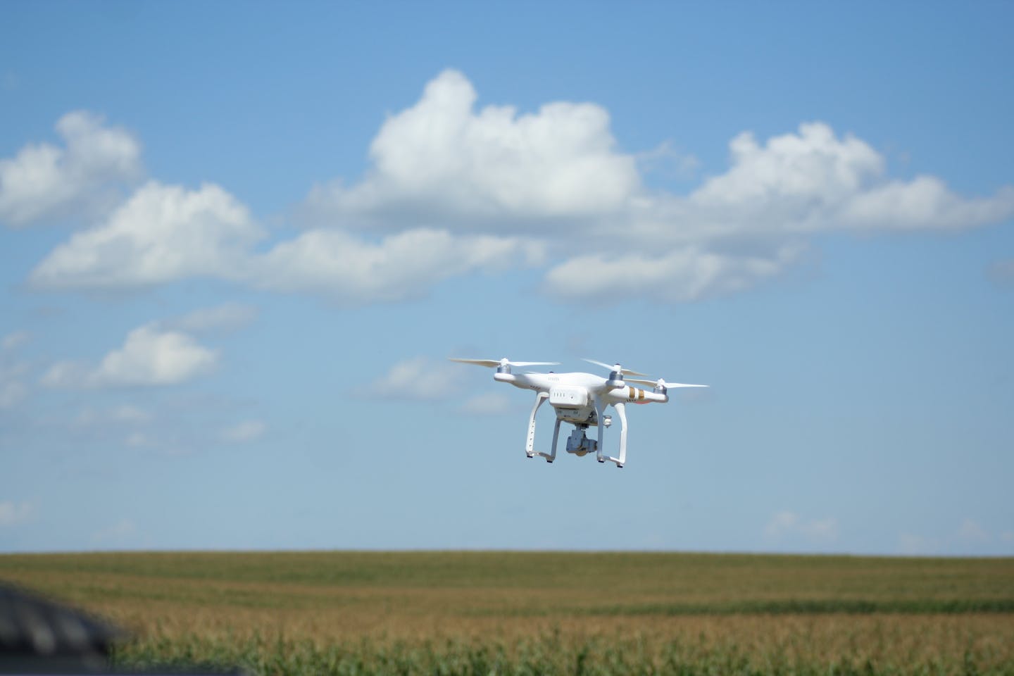 A drone hovers over a farm