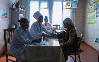 Doctors attend to elderly patient