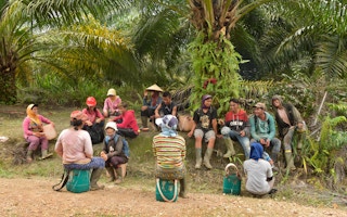 oil palm plantation workers take a rest from work