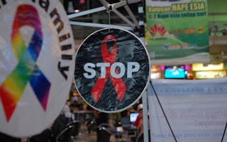 A sticker calls for action against Aids seen in a shopfront in Indonesia