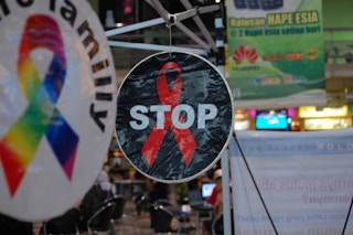 A sticker calls for action against Aids seen in a shopfront in Indonesia