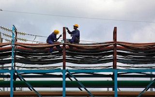 Ghana workers maintaining a thermal power station