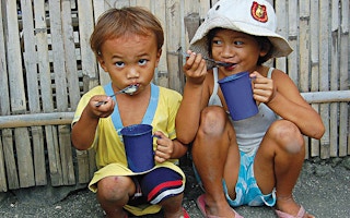 children eat rice and broth 